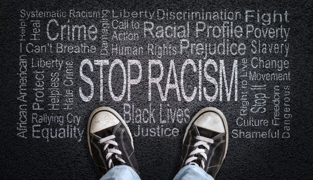 Stop Racism Word Cloud on Asphalt Concept of Fighting Discrimination