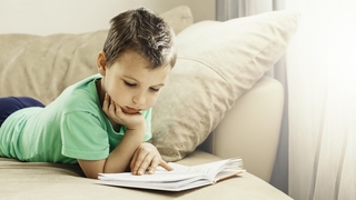 young boy reading crop