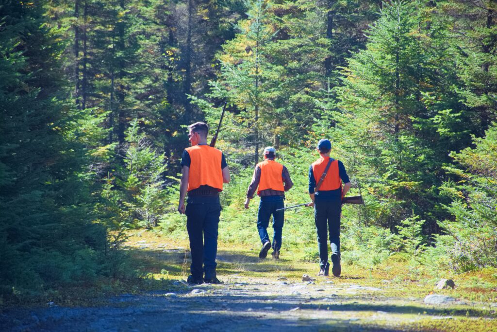 Hunters,In,A,Forest,Trail,On,A,Fall,Day