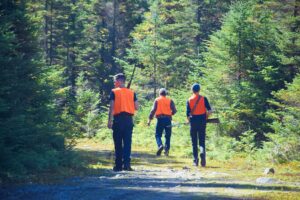 Hunters,In,A,Forest,Trail,On,A,Fall,Day